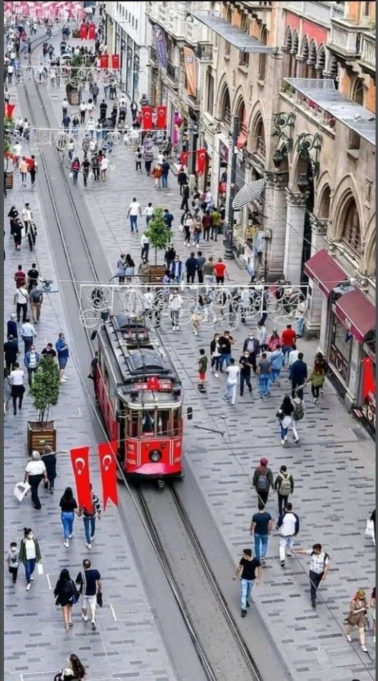 Historic red tram moving through Istiklal Avenue in Istanbul
